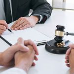 Couple sitting across the desk from a family lawyer